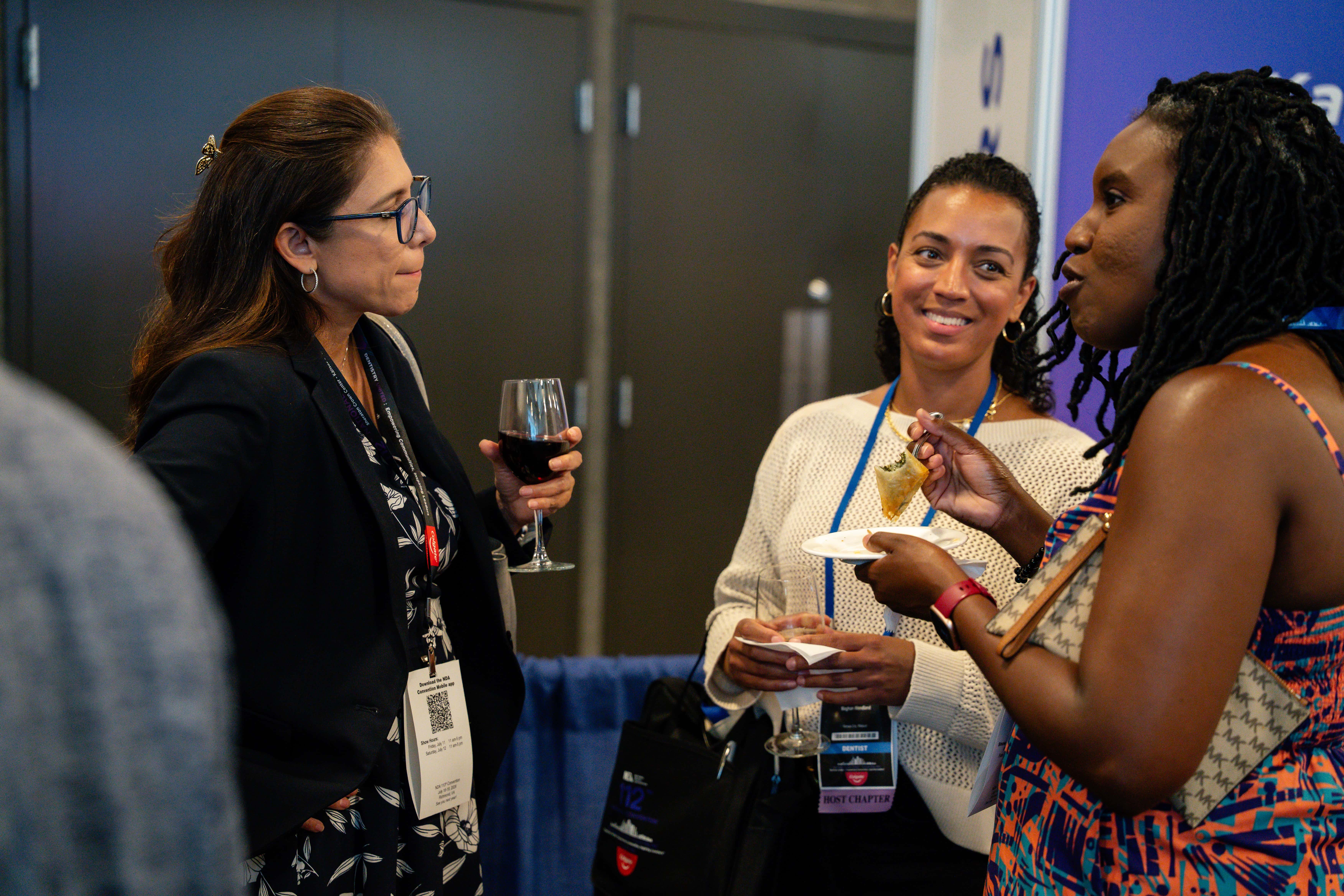 Attendees in conversation at an evening convention reception