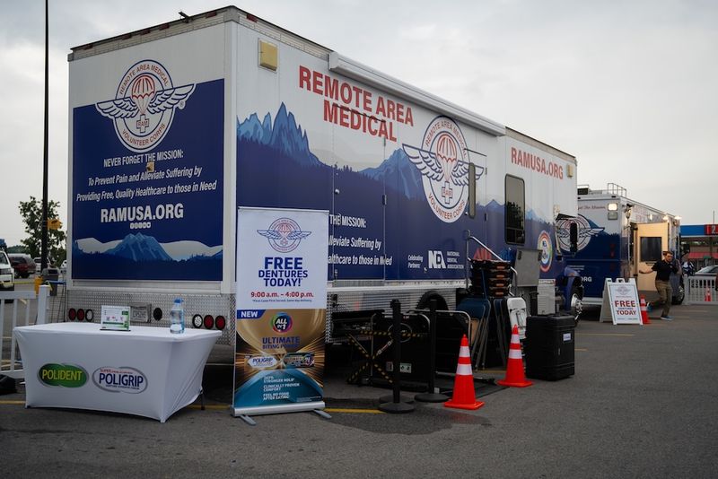 A Remote Area Medical mobile clinic set up in a parking lot, offering free dentures for the day