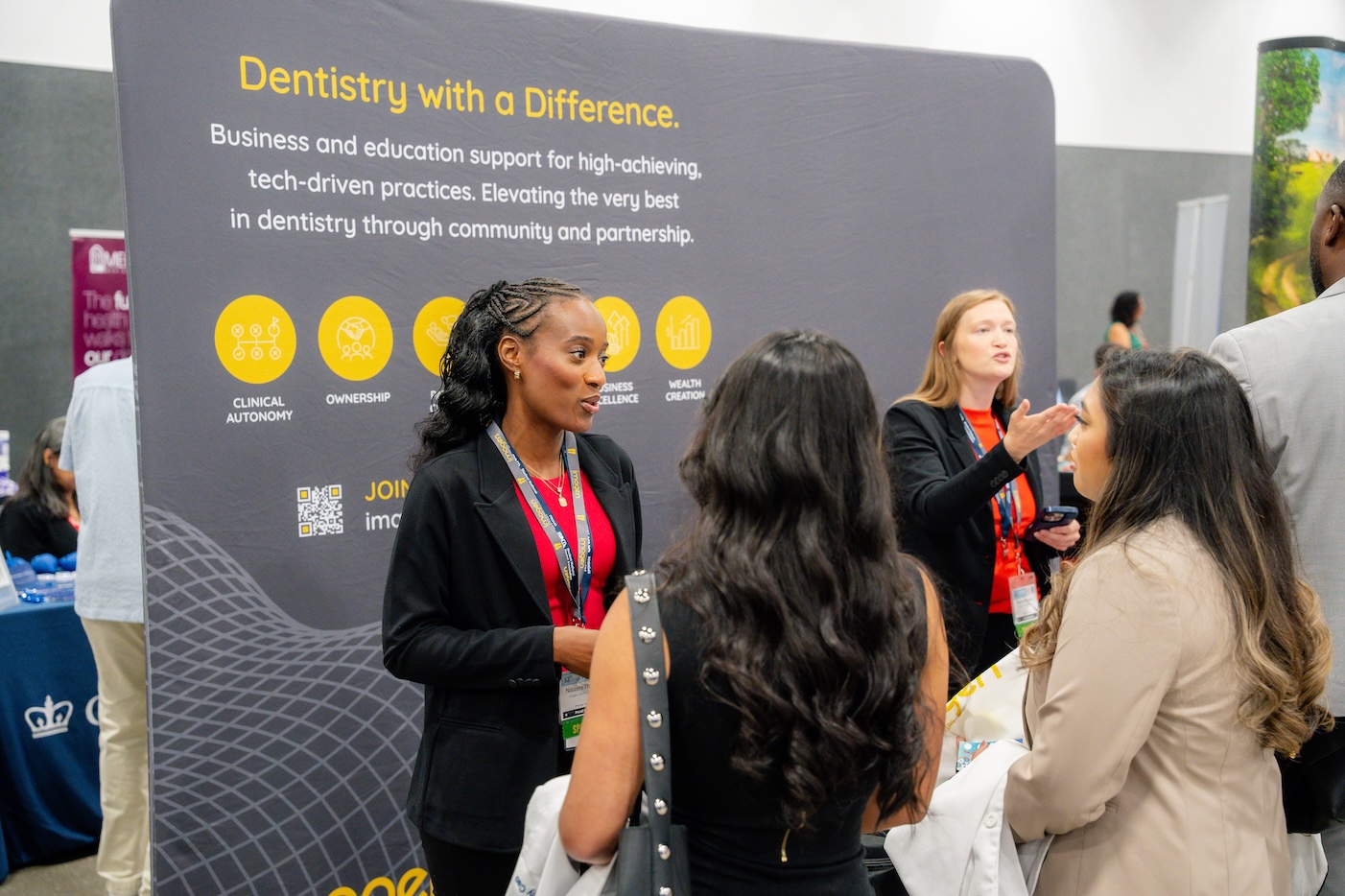 A branded exhibitor stand, with company representatives talking to attendees